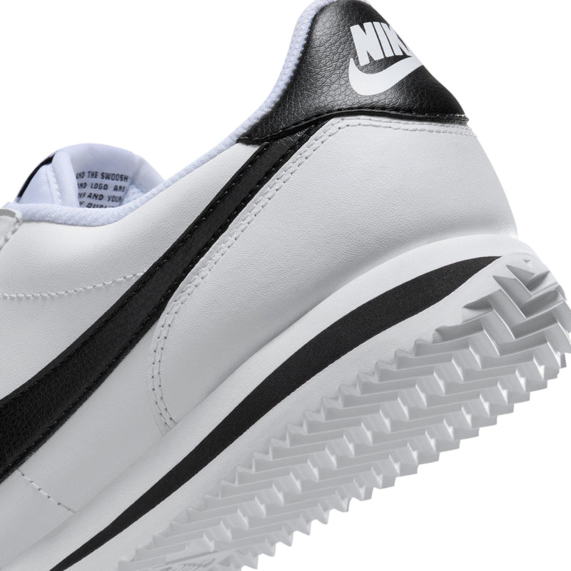 Women's white-and-black sneaker heel with Nike logo and grippy tread sole