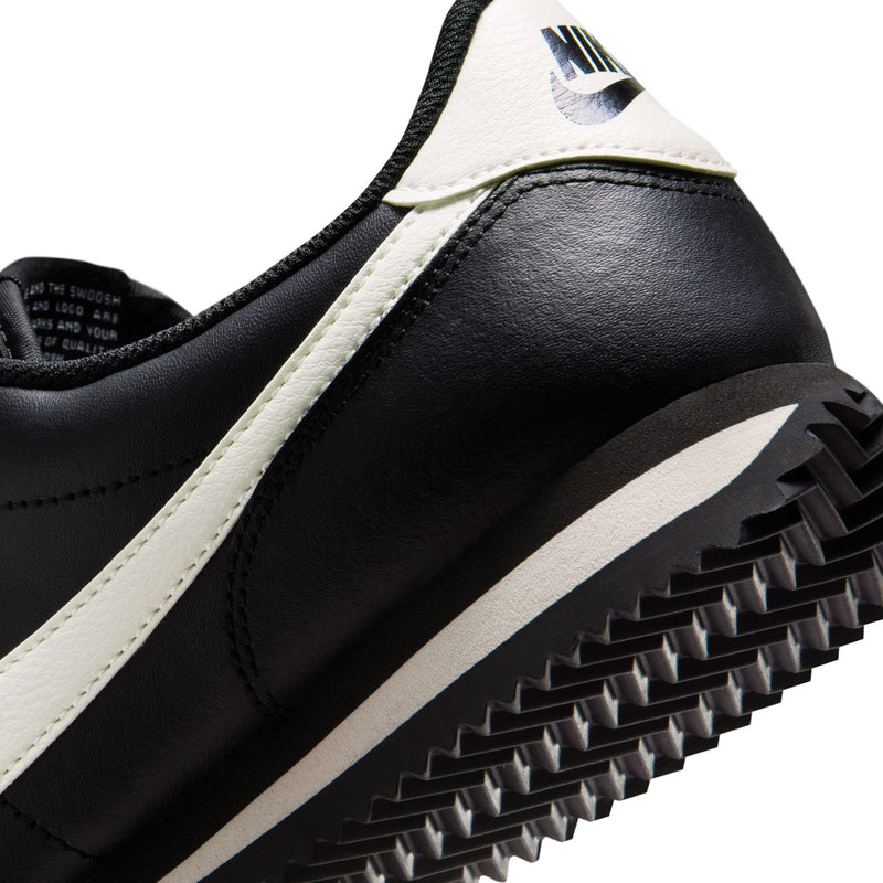 Women's NIKE Cortez sneakers close-up, black and white panels with chunky outsole tread