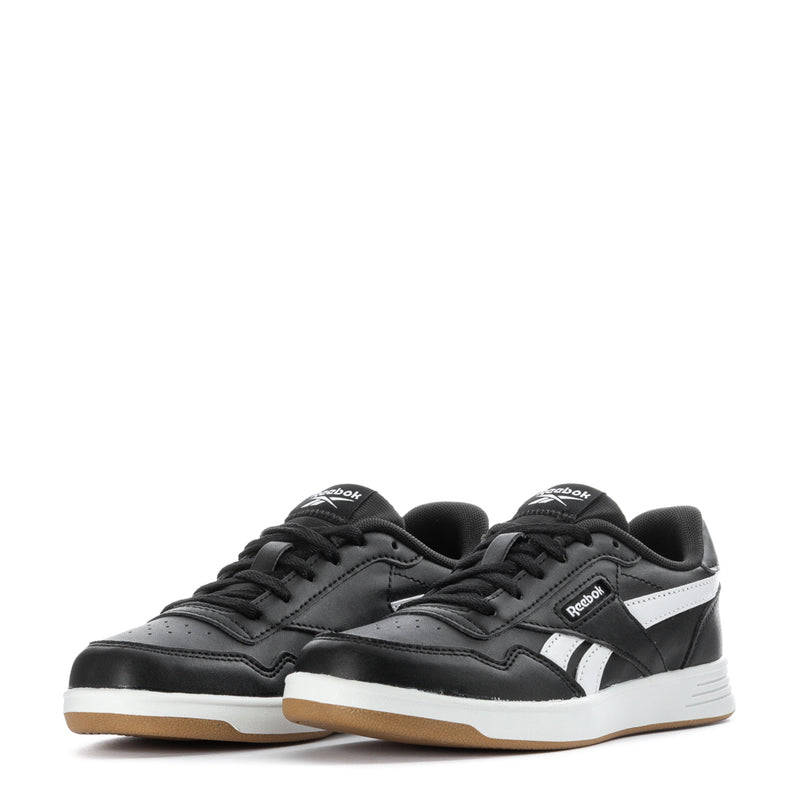 Pair of kids black lace-up sneakers with white stripes and gum midsoles