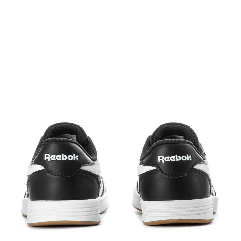Kids black sneakers with white heel accents and gum sole