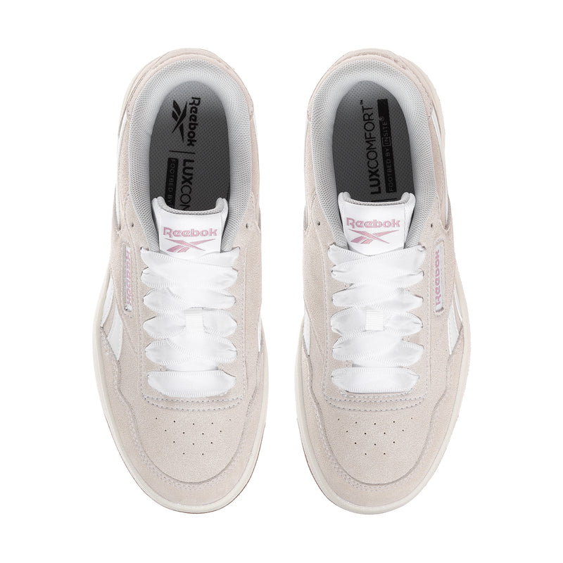 Women’s sneaker interior with white laces, light beige uppers, and comfort insole