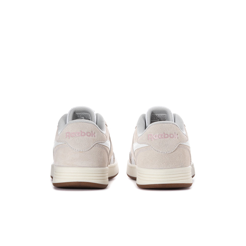 Women’s heel view of light beige lace-up sneaker with white back stripe and gum sole