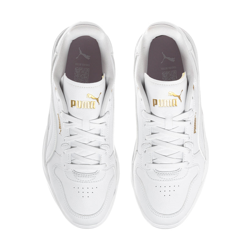 White Puma court sneakers, top view showing gold Puma logo on tongue