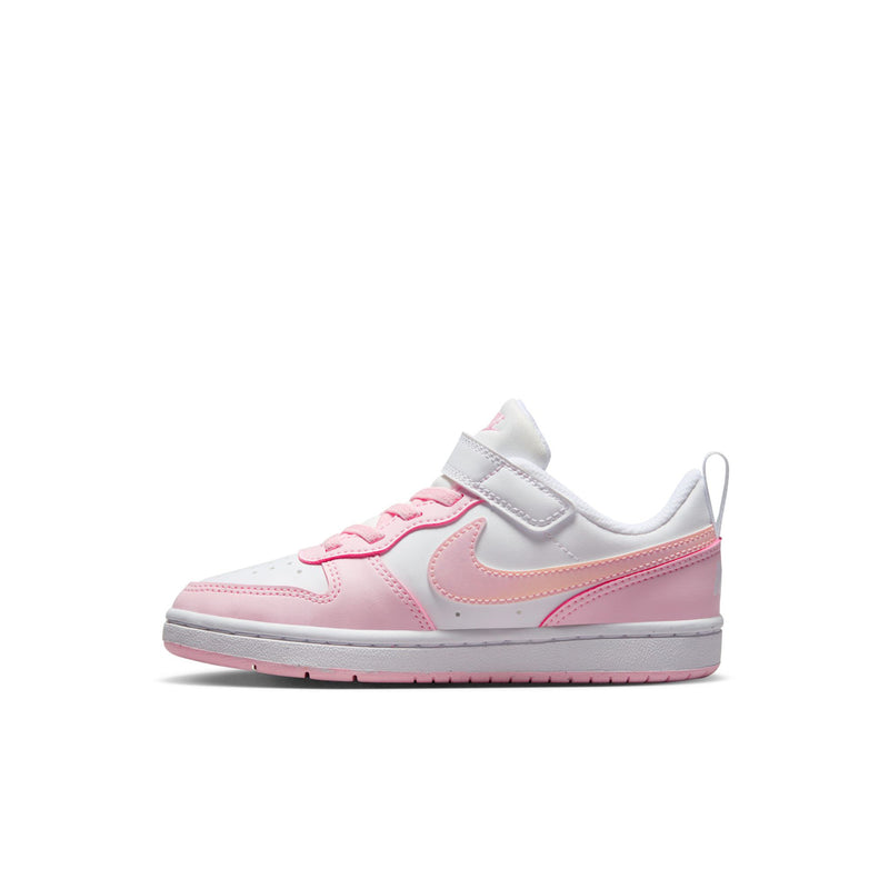 Kids low-top sneakers, angled side view in white with pink paneling and strap