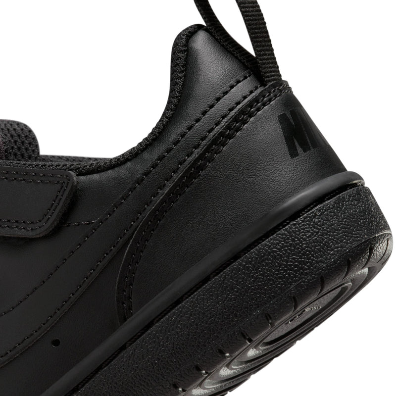 Kids black sneaker side detail with swoosh, lace loops, and air-cushion outsole