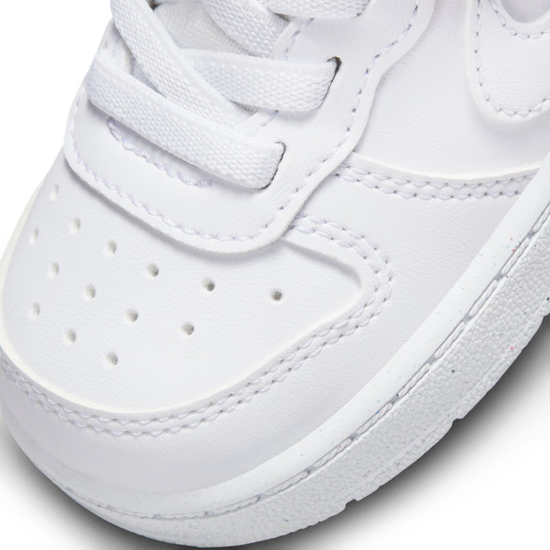Toddler white sneaker detail showing stitched overlays and perforated toe panel