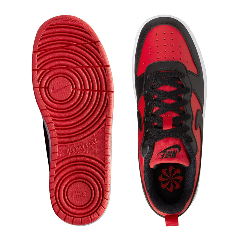 Youth sneakers shown with red outsole tread and black upper side with lace holes