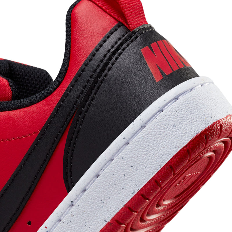 Youth sneaker close-up of heel and Swoosh area with NIKE lettering and red outsole edge