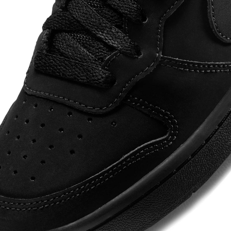 Black youth sneaker upper close-up with perforations, stitched seams, and lace panel