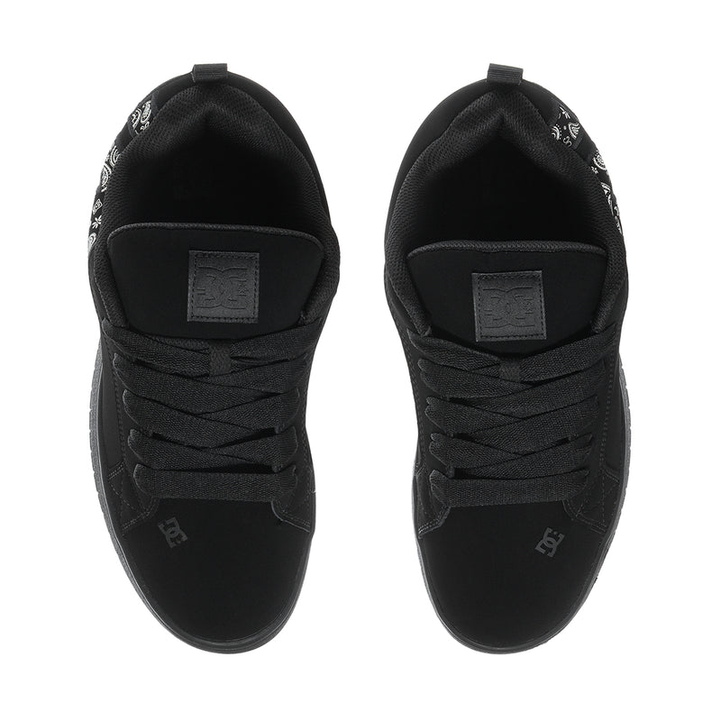 Black low-top sneakers with lace-up front and cushioned heel with label patch.