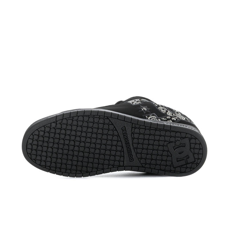 Black outsole with textured tread pattern and DC logo on heel.