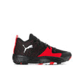 Youth basketball shoe in black with red accents, Puma logo and textured upper.