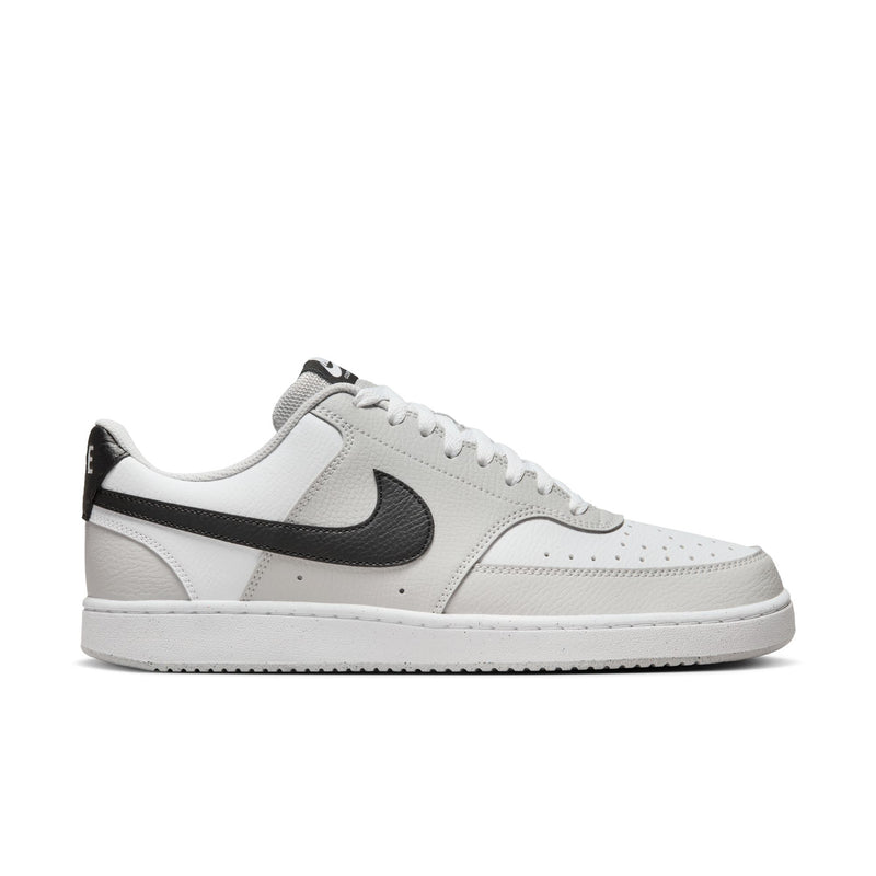 Low-top men's sneaker in white with gray and black swoosh accents, lace-up.