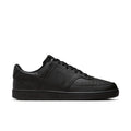 Men's black low-top sneakers with lace-up closure and textured leather-look upper