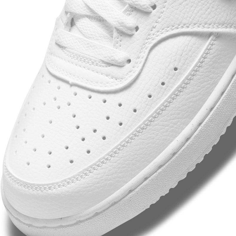 White perforated toe box and lace-up with textured leather on low-top sneaker