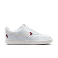 Women's low-top sneaker in off-white with red flower accents and Nike swoosh