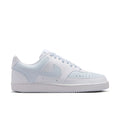 Women's low-top sneakers, white leather with light blue Swoosh and lace-up.