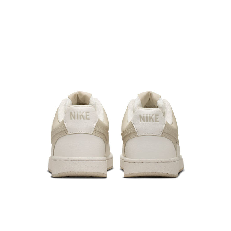 Women's cream low-top sneakers with Nike-branded heel tabs and padded collar