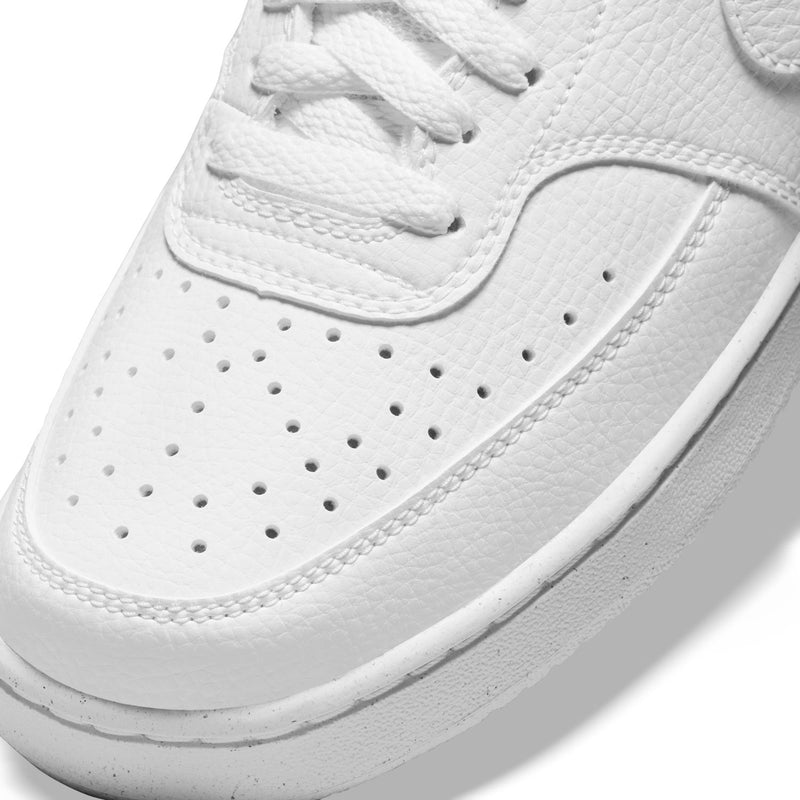 Close-up of white leather sneaker with perforated toe and laced vamp