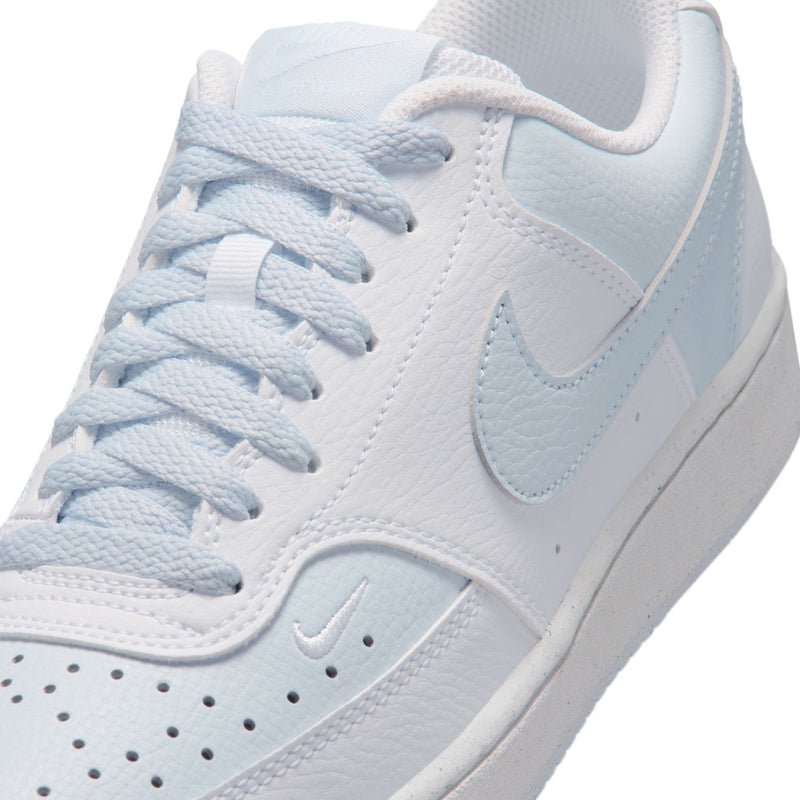 Close-up of women's white and light blue low-top sneaker with lace and Swoosh.