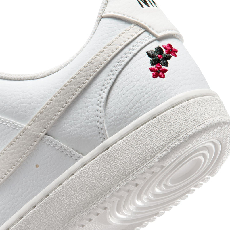 Close-up of off-white sneaker side panel with red flower stitch and midsole tread