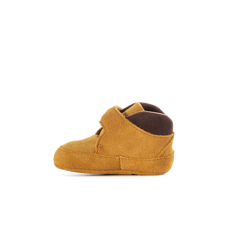 Infant wheat bootie side view with dark brown interior and hook strap