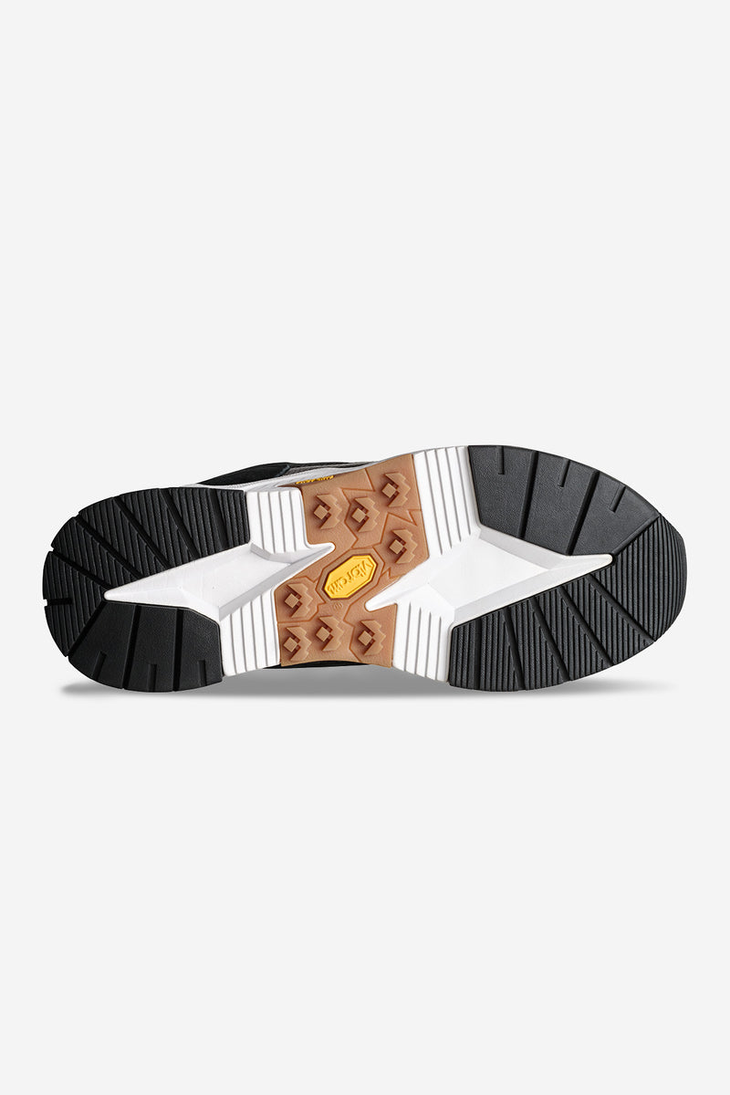 Bottom view of CT-4000 sneaker with rugged black upper white midsole and tan Vibram outsole insert.