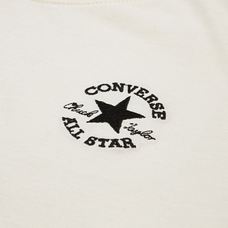 Close-up of Converse All Star star logo embroidery on off-white youth T-shirt