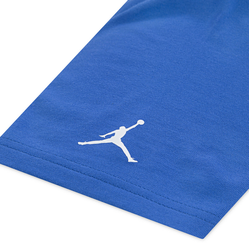 Youth blue T-shirt hem with small white Jordan Jumpman logo