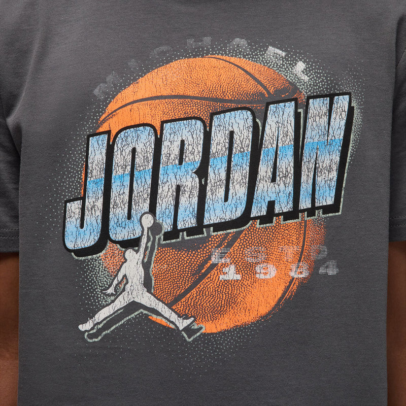 Close-up: distressed Jordan logo graphic on iron grey youth T-shirt front