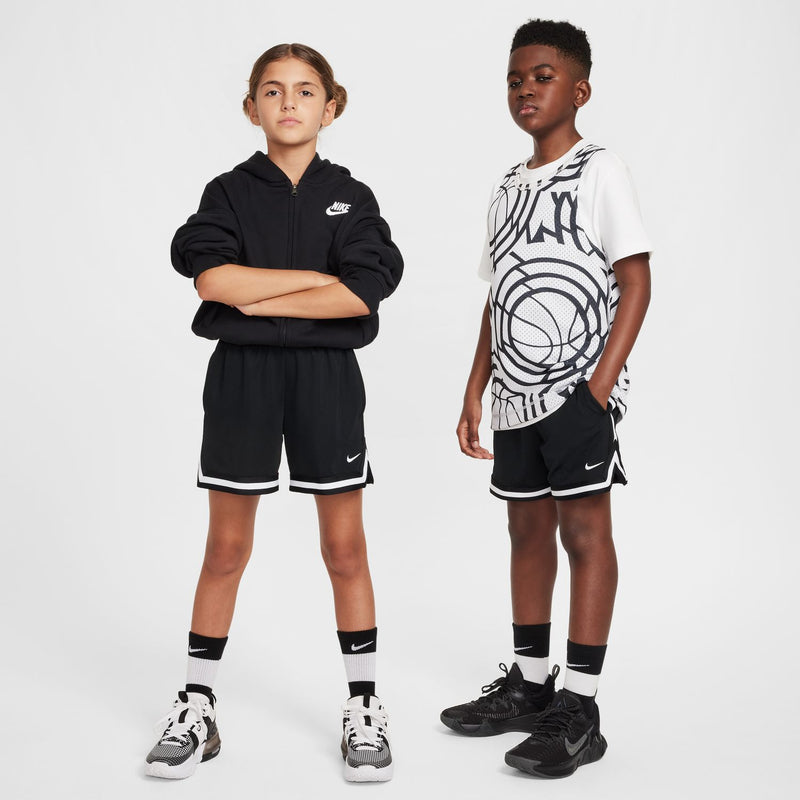 Black youth shorts with elastic waistband and white trim, worn by kids.