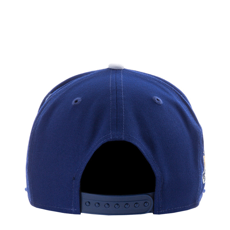 Royal blue baseball cap with open back view and adjustable strap on rear