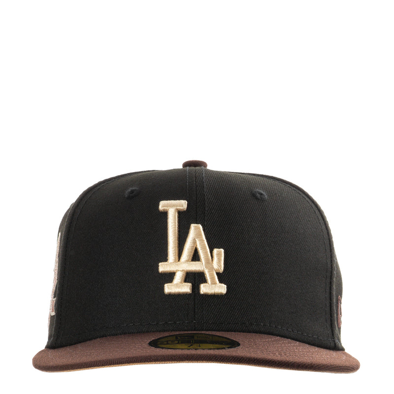 Two-tone black and brown baseball cap with raised LA logo on front
