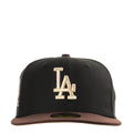 Two-tone black and brown baseball cap with raised LA logo on front