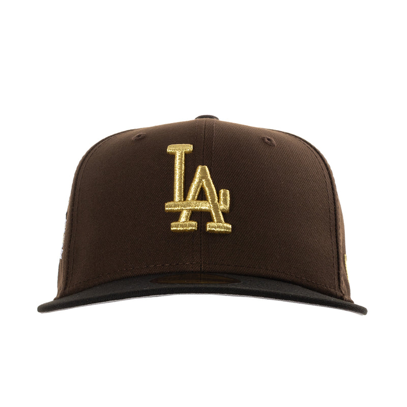 Brown baseball cap with large gold “LA” lettering on the front