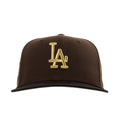 Brown baseball cap with large gold “LA” lettering on the front