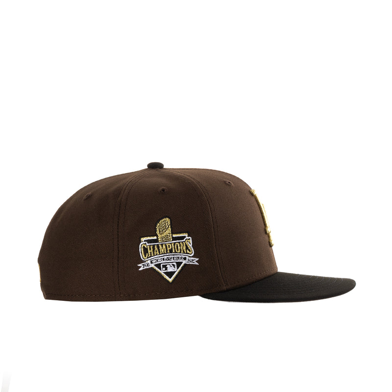 Brown baseball cap with gold “Champions” trophy side patch embroidery