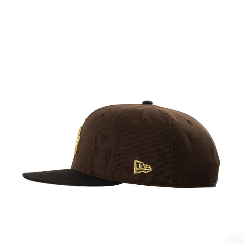 Brown baseball cap with small gold New Era flag logo on the side