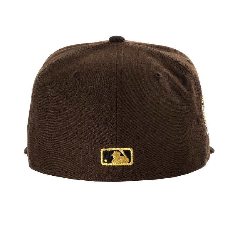 Brown baseball cap with gold square “Champions” patch on the front