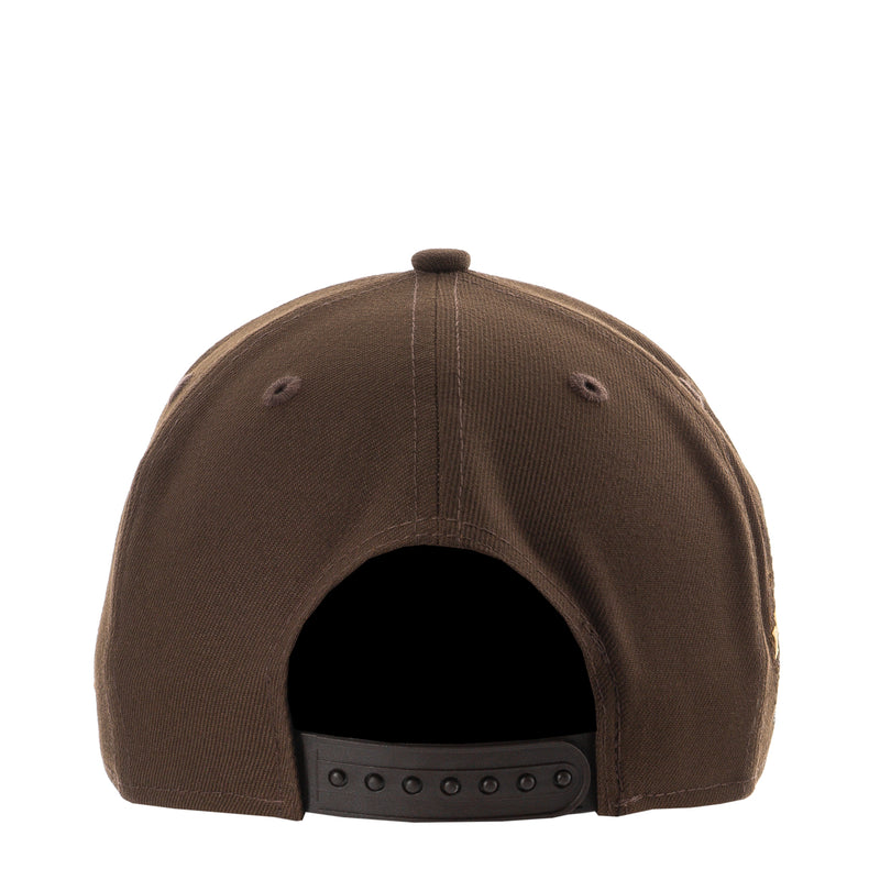 Brown A-frame baseball cap back with adjustable strap and ventilation eyelets