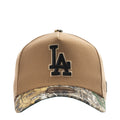 Tan baseball cap with LA embroidered logo and camo-pattern brim