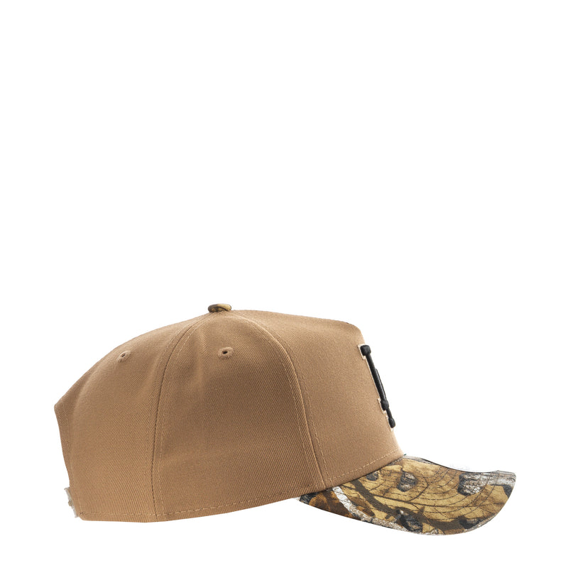 Tan baseball cap, side profile with camo-pattern underbrim and short crown