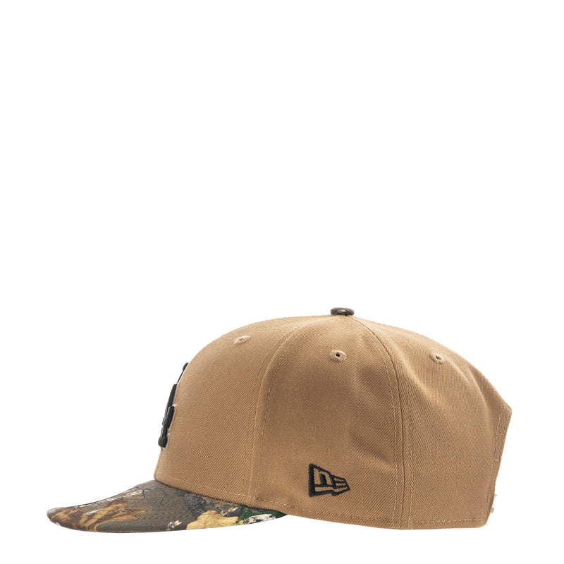 Desert tan baseball cap with New Era flag logo and camo-pattern brim