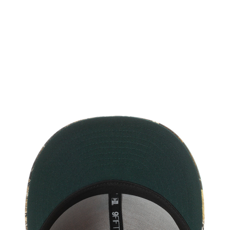 Dark green baseball cap close-up with stitched crown and inner band
