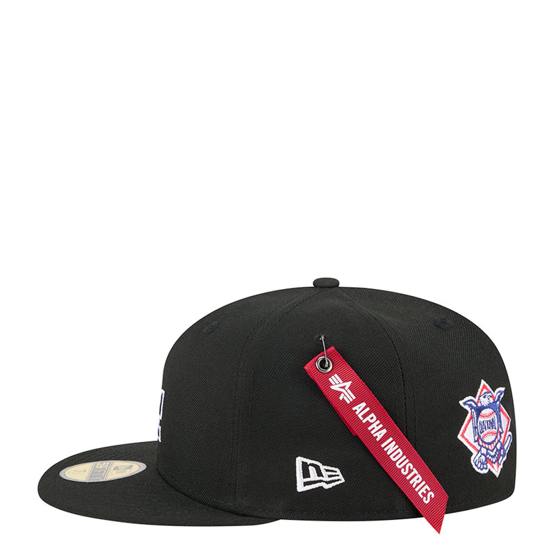 Black baseball cap with red Alpha Industries tag, New Era flag and side patch
