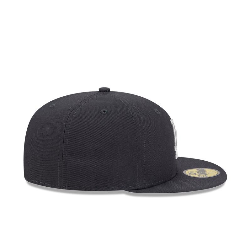 Dark baseball cap with curved brim and side New Era flag patch