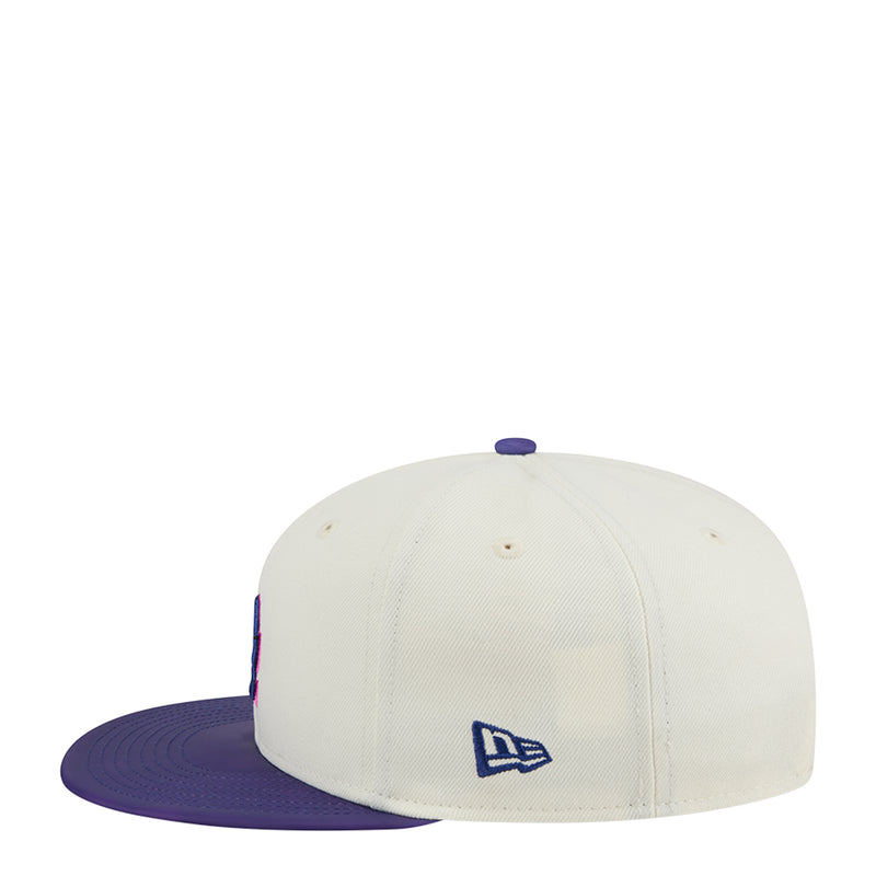 Two-tone baseball cap, cream crown with purple underbill and New Era flag logo.