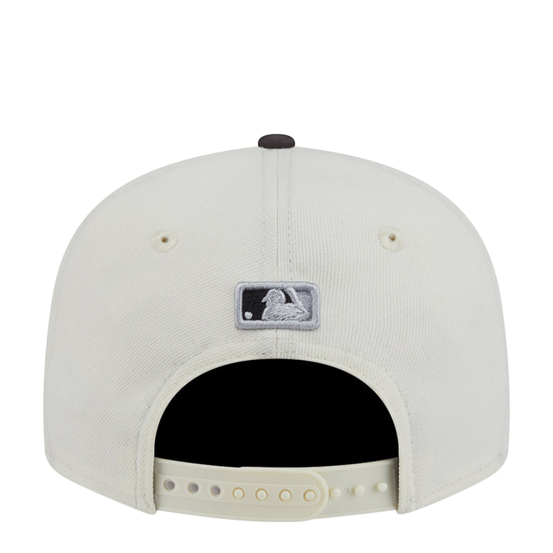 Two-tone baseball cap, white crown with World Series patch and vented back opening