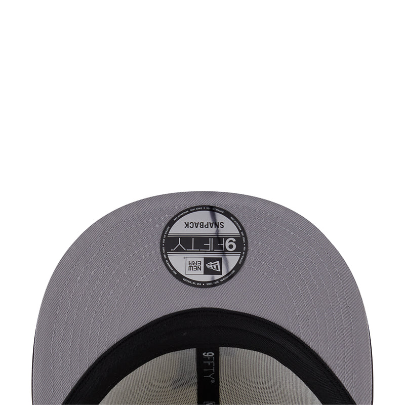 Two-tone baseball cap, dark gray underside with black circular New Era size label