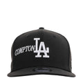 Black baseball cap with white Compton lettering and Los Angeles LA logo on front